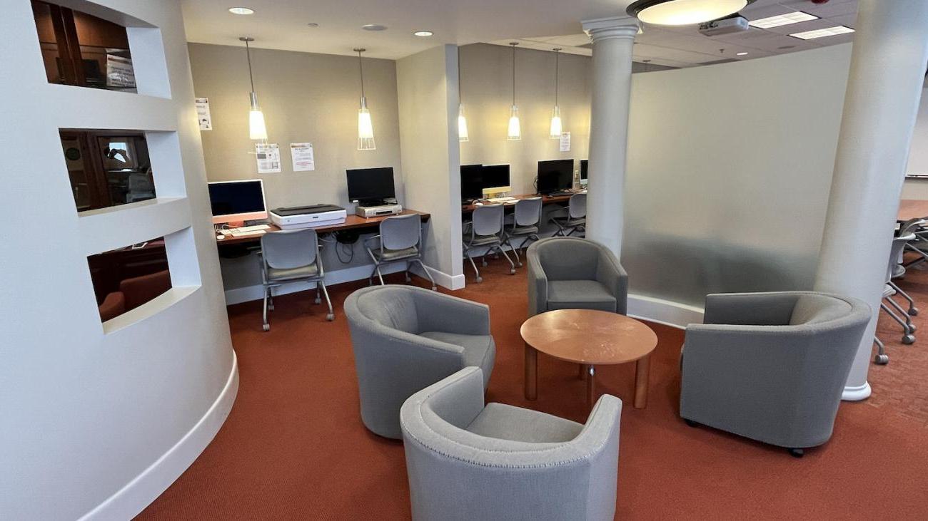 middle section of the FLRC showing chairs around a desk and computers along the backwall